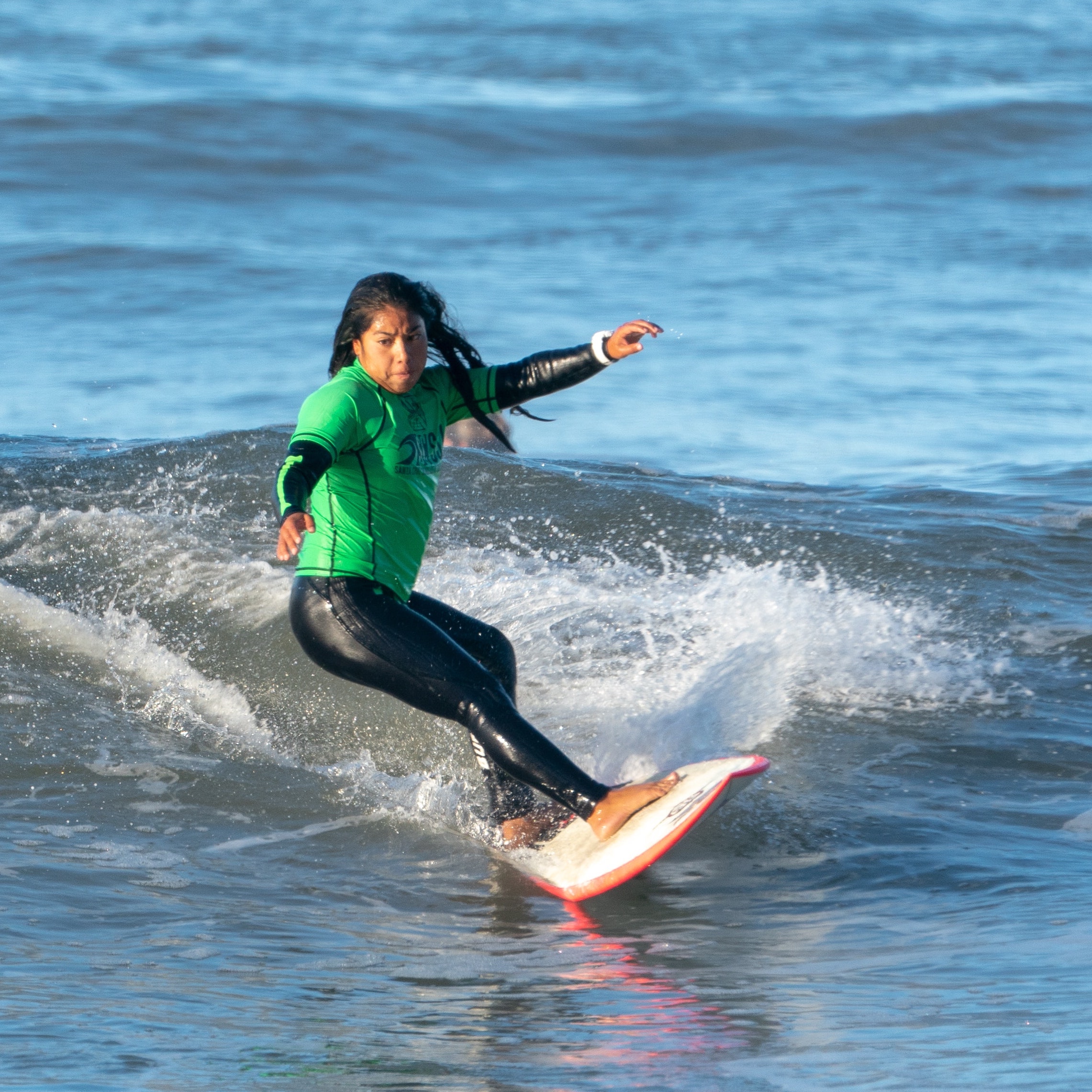 a young woman surfing