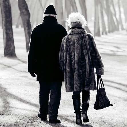 an older couple going for a stroll in the park