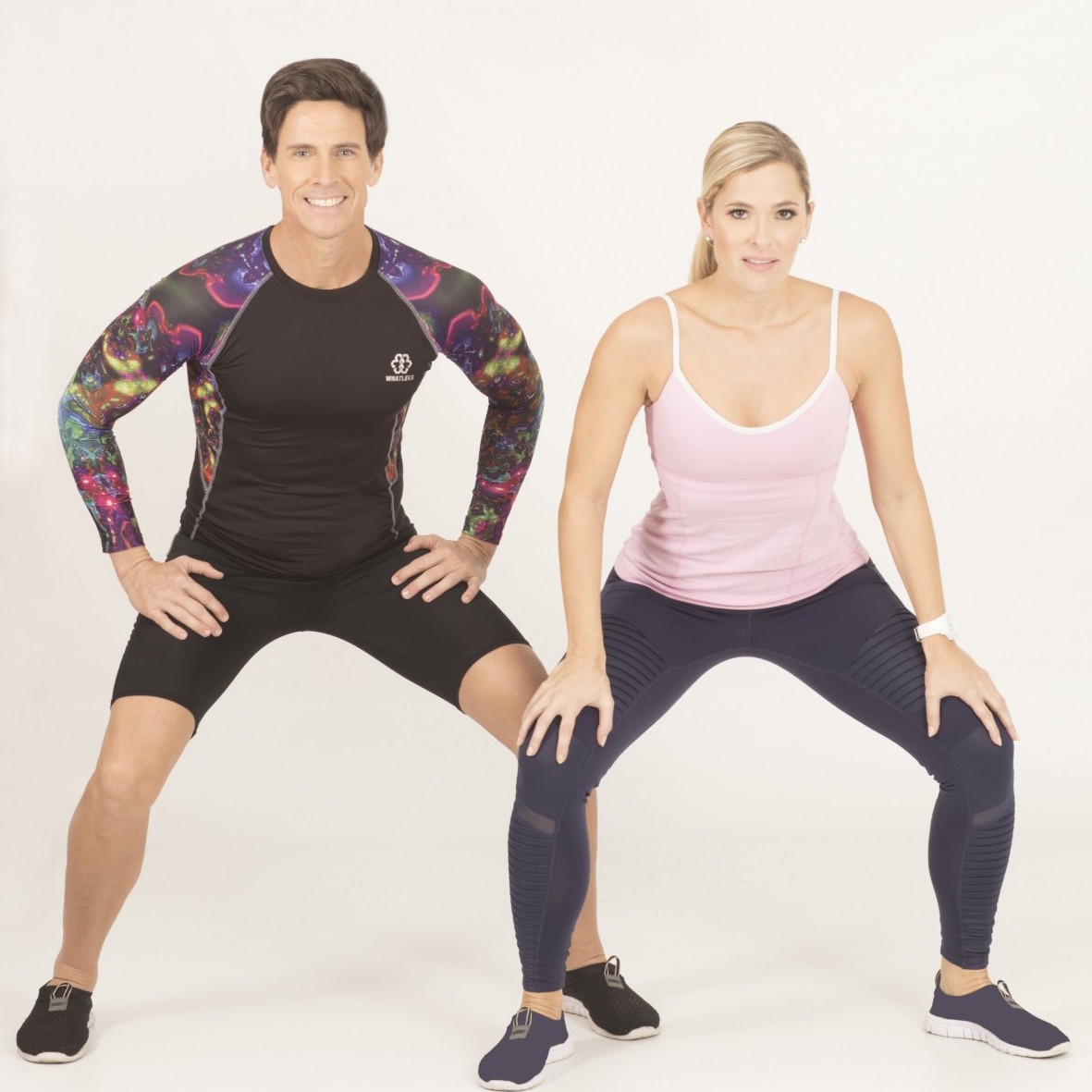 two people squatting awkwardly in workout clothing